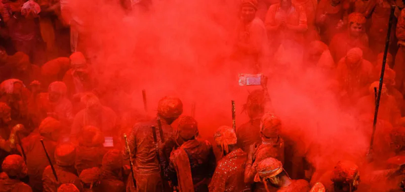Clouds of red colour over the crowd at Lathmar Holi in Barsana, near Mathura
